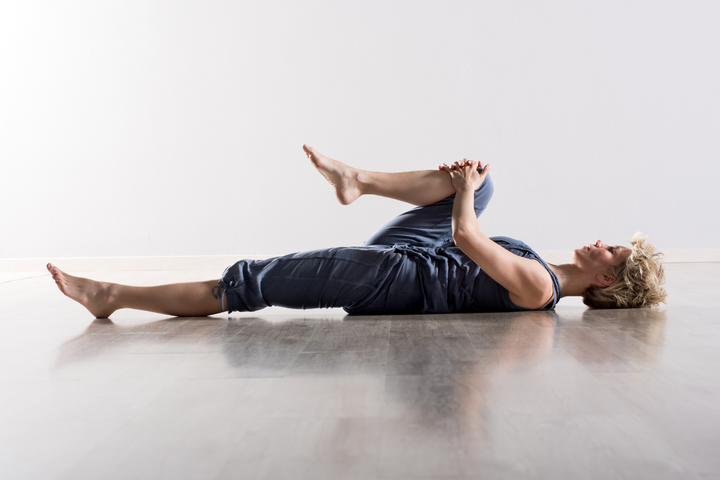 Looking After Your Joints and importance of Joint Health Lady stretching her legs on a yoga mat